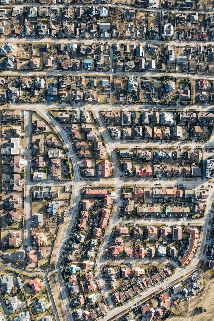 High-angle aerial view of a dense suburban neighborhood with organized streets and houses.